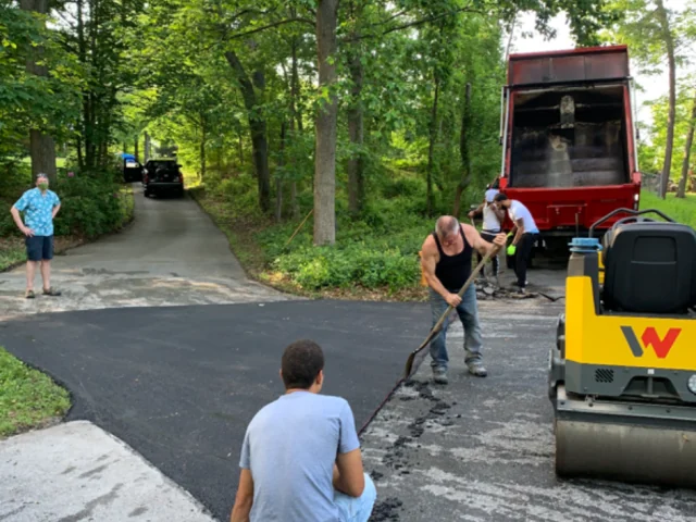 South State Paving crew finishing the edges of a new driveway South State Paving crew finishing the edges of a new driveway